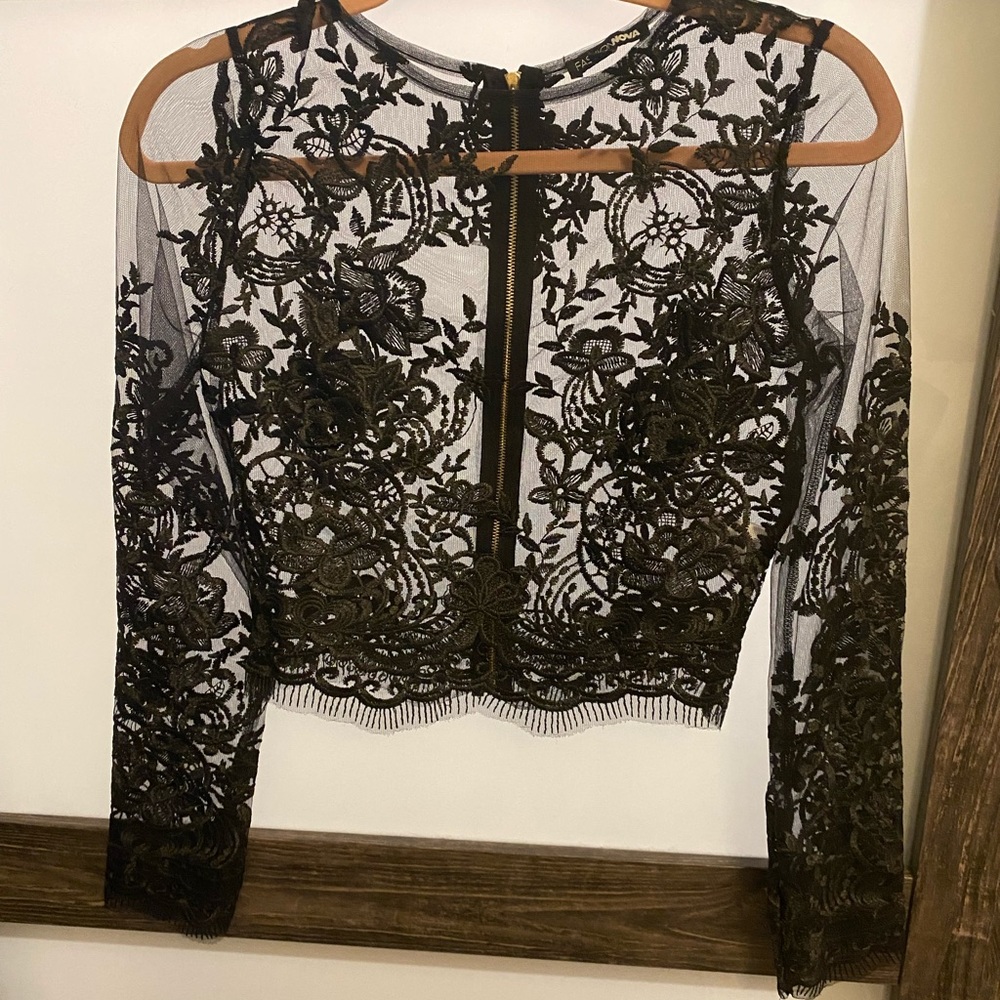 Lace top with zipper in the back. SIZE SMALL. Never been worn.
